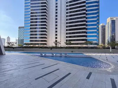 a swimming pool in a city with tall buildings at Frank Porter - Marquise Square Tower in Dubai