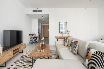 a living room with a couch and a television at Frank Porter - Marquise Square Tower in Dubai