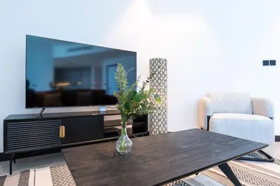 a vase of flowers on a table in a living room at Contemporary Ranch Living with Burj Khalifa View in Dubai