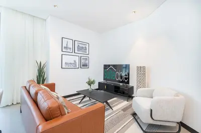 a living room with a couch and a chair at Contemporary Ranch Living with Burj Khalifa View in Dubai