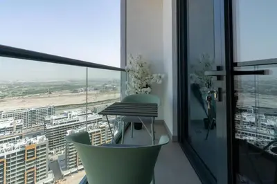 a balcony with a table and a view of a city at Modern 1bdr - 10min from Burj Khalifa - Sobha Waves in Dubai