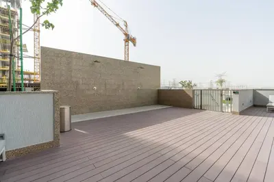a balcony of a building with a wooden floor at Modern 1bdr - 10min from Burj Khalifa - Sobha Waves in Dubai