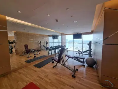 a gym with treadmills and exercise equipment in a building at Opulent Studio at Carson C DAMAC Hills Dubailand by Deluxe Holiday Homes in Dubai