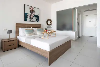 a bedroom with a large bed and a large screen at Frank Porter - Palm Views East in Dubai