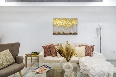 a living room with a couch and a table at The Smart Concierge - Princess tower in Dubai