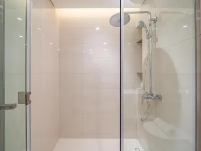 a bathroom with a glass shower with a toilet at Exceptional 2BR-Private Beach Access-Palm Jumeirah in Dubai