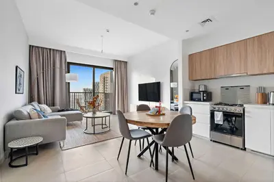 a kitchen and living room with a table and chairs at Silkhaus new 1BDR in Executive Residence 2 in Dubai