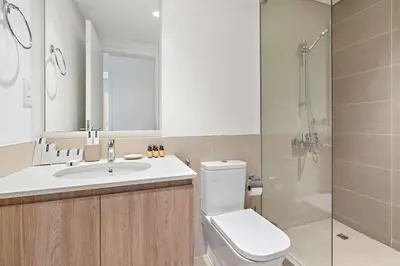 a bathroom with a toilet and a sink and a shower at Silkhaus new 1BDR in Executive Residence 2 in Dubai