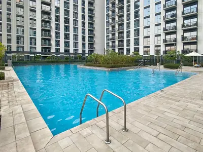 a large swimming pool in front of a building at Silkhaus new 1BDR in Executive Residence 2 in Dubai