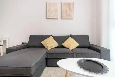 a living room with a couch and a table at Central 1bdr - Al Quoz - Al Khail Height in Dubai