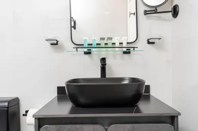 a bathroom with a black sink and a mirror at Central 1bdr - Al Quoz - Al Khail Height in Dubai
