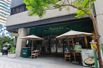 a restaurant with tables and umbrellas in front of a building at Dunya Tower Luxury and 2 min walk to Dubai Mall and Burj Khalifa in heart of Downtown in Dubai