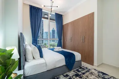a bedroom with a large bed and a large window at Dunya Tower Luxury and 2 min walk to Dubai Mall and Burj Khalifa in heart of Downtown in Dubai