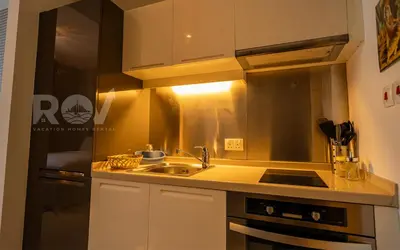 a kitchen with a sink and a stove at Studio with Boulevard View in Dubai