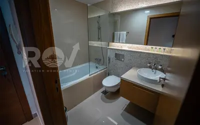 a bathroom with a sink and a toilet and a tub at Studio with Boulevard View in Dubai