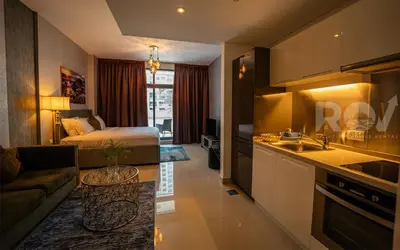 a kitchen and a living room with a bed at Studio with Boulevard View in Dubai