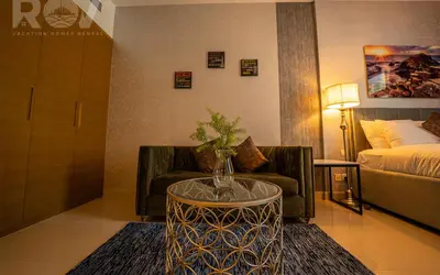 a living room with a couch and a coffee table at Studio with Boulevard View in Dubai