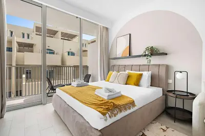 a bedroom with a large bed and a large window at Silkhaus new studio in JVC with queen Bed in Dubai