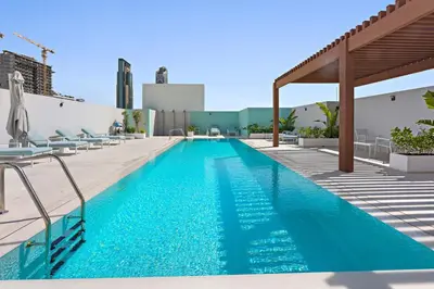 a swimming pool on top of a building at Silkhaus new studio in JVC with queen Bed in Dubai