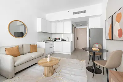 a living room with a couch and a table at Silkhaus new studio in JVC with queen Bed in Dubai