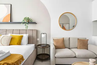 a living room with a bed and a couch at Silkhaus new studio in JVC with queen Bed in Dubai