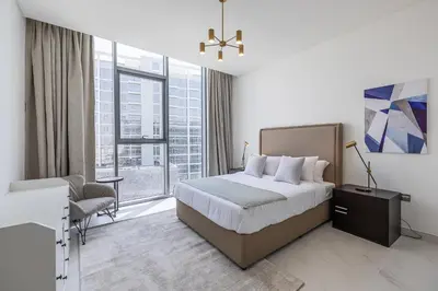 a hotel room with a bed and a window at Fully Furnished I Lagoons View I District One in Dubai