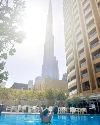 a woman in a swimming pool in a city at Fashion Avenue Dubai Mall in Dubai