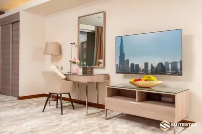 a room with a desk and a television and a chair at Fashion Avenue Dubai Mall in Dubai
