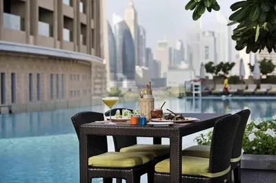 a table with food and drinks on it with a view of the city at Fashion Avenue Dubai Mall in Dubai
