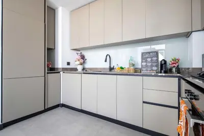 a kitchen with white cabinets and a sink at Frank Porter - 15 Northside Tower 2A in Dubai