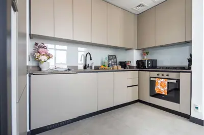 a kitchen with white cabinets and an oven at Frank Porter - 15 Northside Tower 2A in Dubai