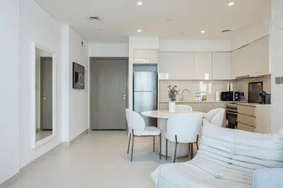 a kitchen and living room with a table and chairs at SmartStay at Burj Royale - Full Burj Khalifa View - Brand New Luxury Apartments in Dubai