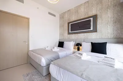 two beds in a hotel room with two beds sidx sidx sidx at SmartStay at Burj Royale - Full Burj Khalifa View - Brand New Luxury Apartments in Dubai