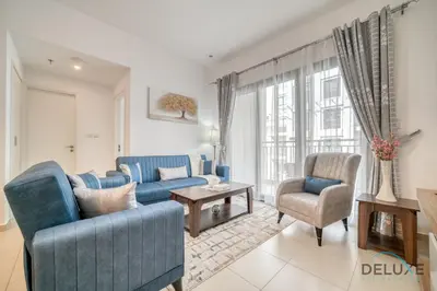 a living room with a blue couch and two chairs at Soothing 1BR at Safi 1B Town Square Dubailand by Deluxe Holiday Homes in Dubai