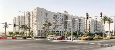 a large apartment building with cars parked in a parking lot at Soothing 1BR at Safi 1B Town Square Dubailand by Deluxe Holiday Homes in Dubai