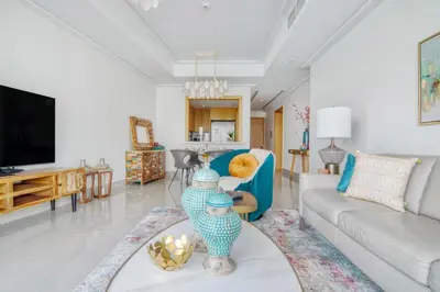 a living room with a couch and a tv at Luxury 2BR Apartment with Stunning Burj Khalifa & Fountain Views - Opera Grand, Downtown in Dubai