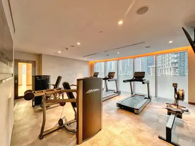 a gym with treadmills and exercise equipment in a building at Luxury 2BR Apartment with Stunning Burj Khalifa & Fountain Views - Opera Grand, Downtown in Dubai