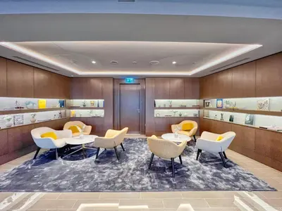 a restaurant with tables and chairs and shelves at Luxury 2BR Apartment with Stunning Burj Khalifa & Fountain Views - Opera Grand, Downtown in Dubai