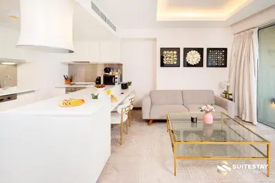 a kitchen and living room with a couch and a table at Fashion avenue Dubai Mall -The Residence in Dubai