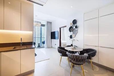 a kitchen and dining room with a table and chairs at Marina Gate One Bedroom Apartment in Dubai