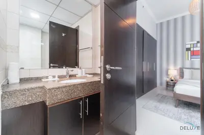 a bathroom with a sink and a large mirror at Scenic 1BR at Bay Central 1 Dubai Marina by Deluxe Holiday Homes in Dubai