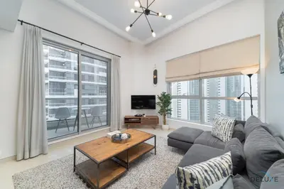 a living room with a couch and a table at Scenic 1BR at Bay Central 1 Dubai Marina by Deluxe Holiday Homes in Dubai