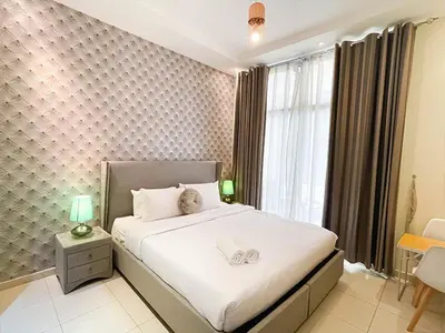 a bedroom with a large white bed with a window at RH- City Living in Style, Large 1 BR with open Terrace, Dubai Marina in Dubai