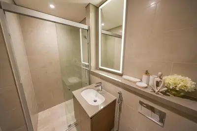 a bathroom with a sink and a mirror at Bright Apartment With Panoramic CityScape Views in Dubai