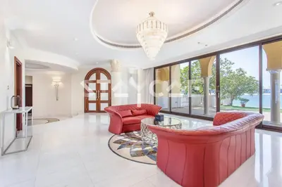a living room with red furniture and large windows at Staycae Palm Jumeirah Villa in Dubai