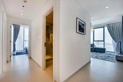 a hallway with white walls and a living room at Fantastic 2BD apartment in Dubai Creek Harbour in Dubai
