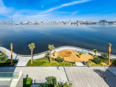 a view of a body of water with palm trees at Fantastic 2BD apartment in Dubai Creek Harbour in Dubai