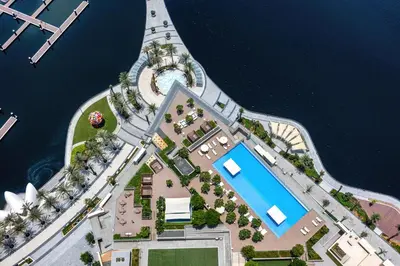 an aerial view of a resort with a pool at Fantastic 2BD apartment in Dubai Creek Harbour in Dubai