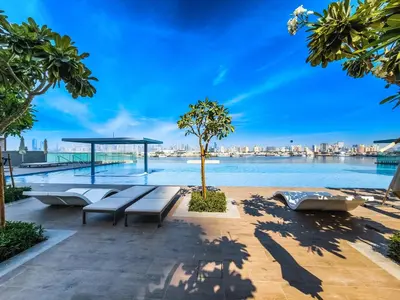a view of the water with benches and trees at Fantastic 2BD apartment in Dubai Creek Harbour in Dubai