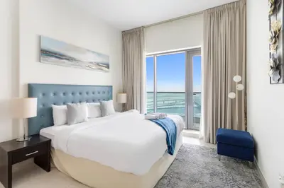 a bedroom with a large bed and a large window at Spacious 1 bedroom in Business Bay - Close to Downtown in Dubai